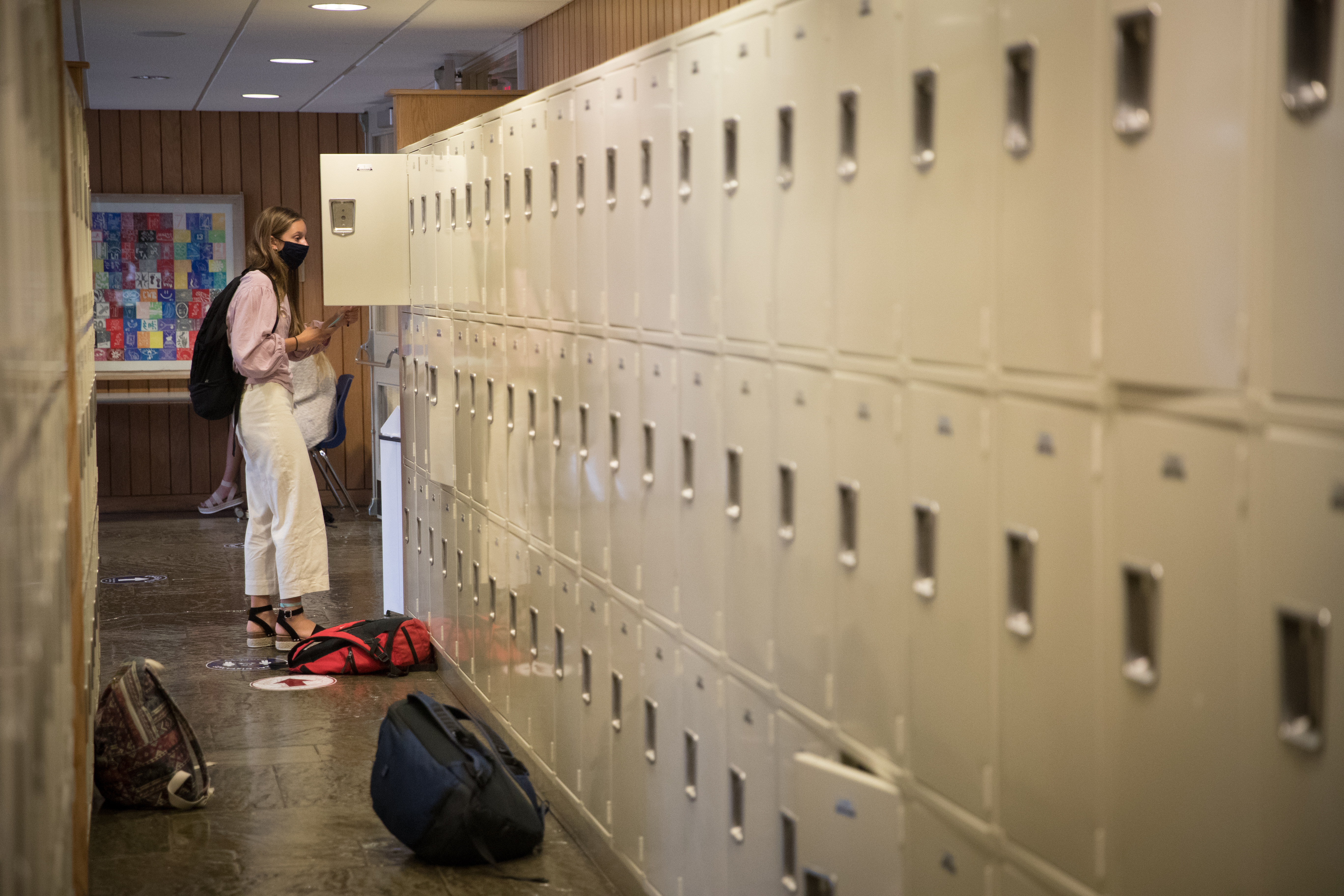 Boarding school student in front of lockers at Tabor Academy